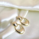 About us vintage inspired polished gold oval drop earrings